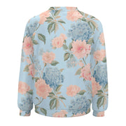 Floral patterned sweatshirt with pink and blue flowers on a light blue background