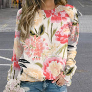 Person wearing a floral long-sleeve shirt with a blurred background