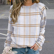 Person wearing a plaid shirt with a blurred background