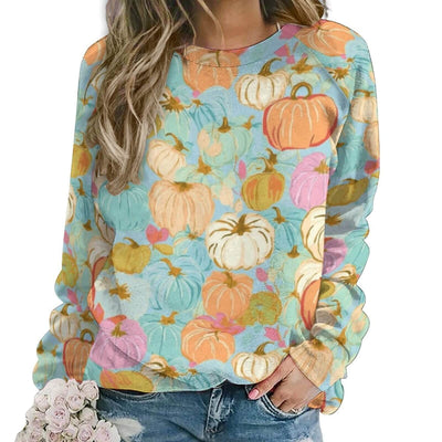 Colorful pumpkin-patterned sweatshirt worn by a person on a white background