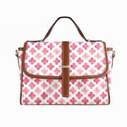 Goldene Handtasche aus floralem Leder
