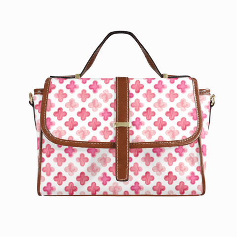 Goldene Handtasche aus floralem Leder